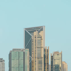 Low angle view of modern buildings against clear blue sky