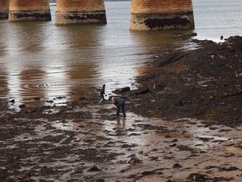 Man standing on rock by sea