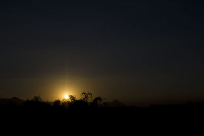 Silhouette landscape against sky at sunset