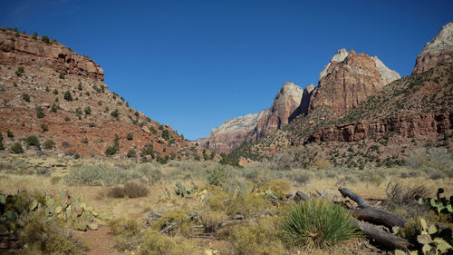 Scenic view of rocky mountains against clear blue sky