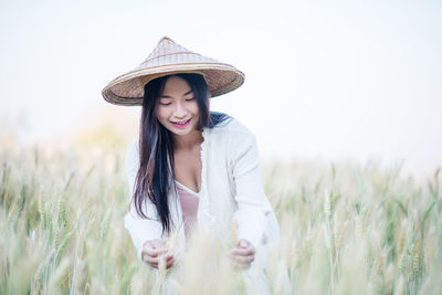Smiling woman standing on field