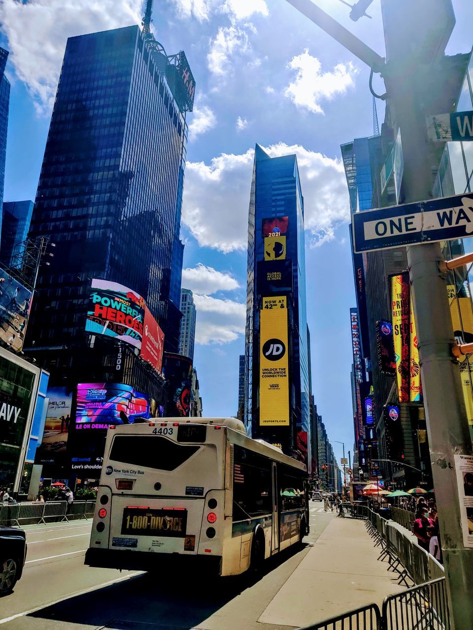 CITY STREET AMIDST BUILDINGS AGAINST SKY