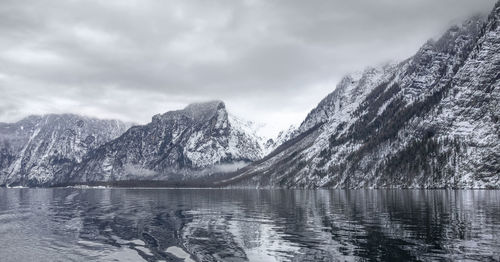 Scenic view of lake and snowcapped mountains against sky