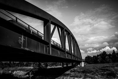 Low angle view of train on bridge against sky