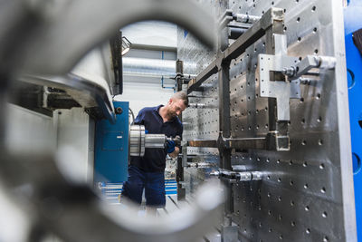 Man working on machine in industrial factory