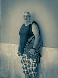 Portrait of man standing against wall