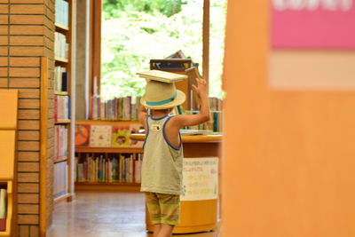 Boy standing on book