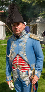 Portrait of man holding umbrella while standing outdoors