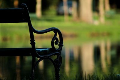 Close-up of empty bench in park