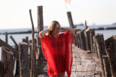 Full length of young woman standing at beach