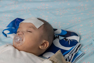 Portrait of cute baby lying on bed