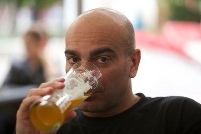 Portrait of mature man drinking beer from glass