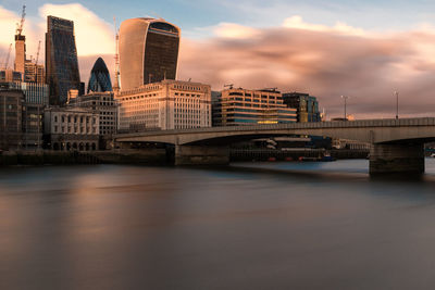 Bridge over river with city in background