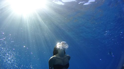 Low angle view of woman swimming in sea