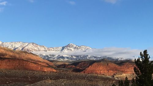 Scenic view of mountains against clear blue sky