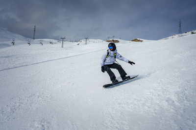 Man skiing on snow covered field