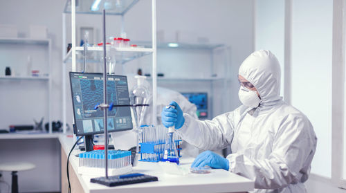 Midsection of scientist working in laboratory