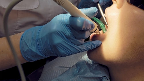 Cropped image of dentist examining patient