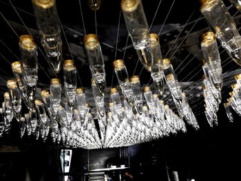 Low angle view of illuminated lanterns hanging on ceiling in restaurant