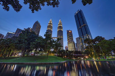 Panoramic view of buildings and trees against sky in city