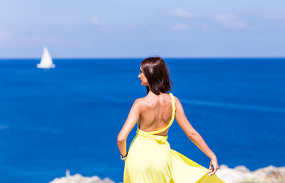 Rear view of woman against sea