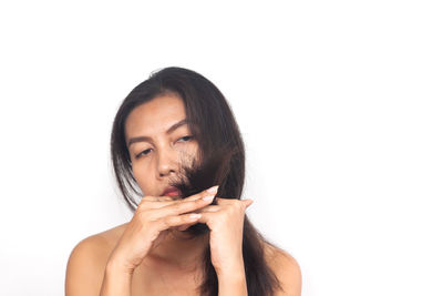 Portrait of a young woman over white background