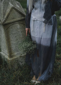 Rear view of woman standing on field