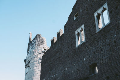 Low angle view of old building against clear sky