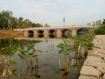 Bridge over lake against sky