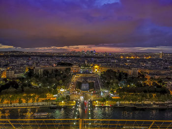 Aerial view of illuminated paris against sunset sky