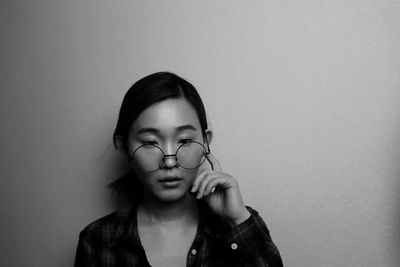 Portrait of young woman against white background