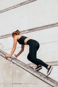 Low section of woman exercising on bridge