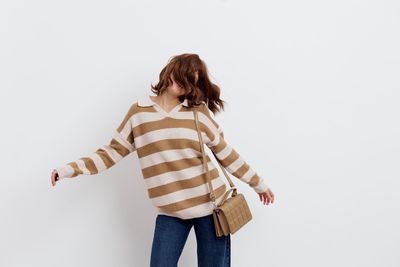 Rear view of woman standing against white background