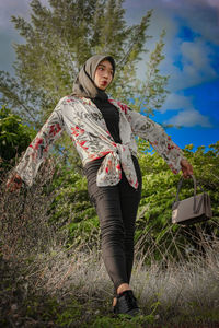 Full length portrait of woman on field