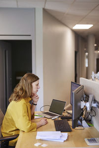 Woman using computer in office