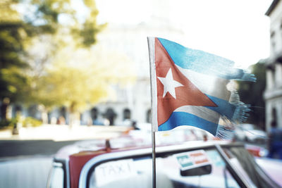 Close-up of cuban flag on taxi