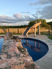 View of swimming pool in city against sky