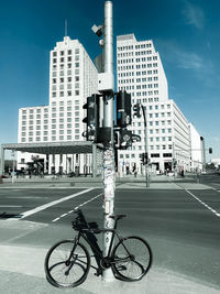 Bicycle on city street against buildings