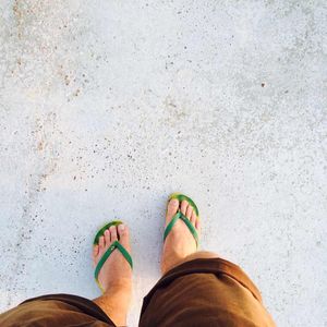 Low section of woman standing on tiled floor