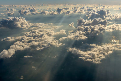 Blue sky and clouds as seen through window of aircraft.