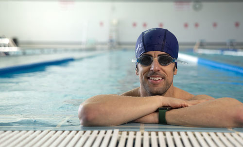 Portrait of shirtless man swimming in pool