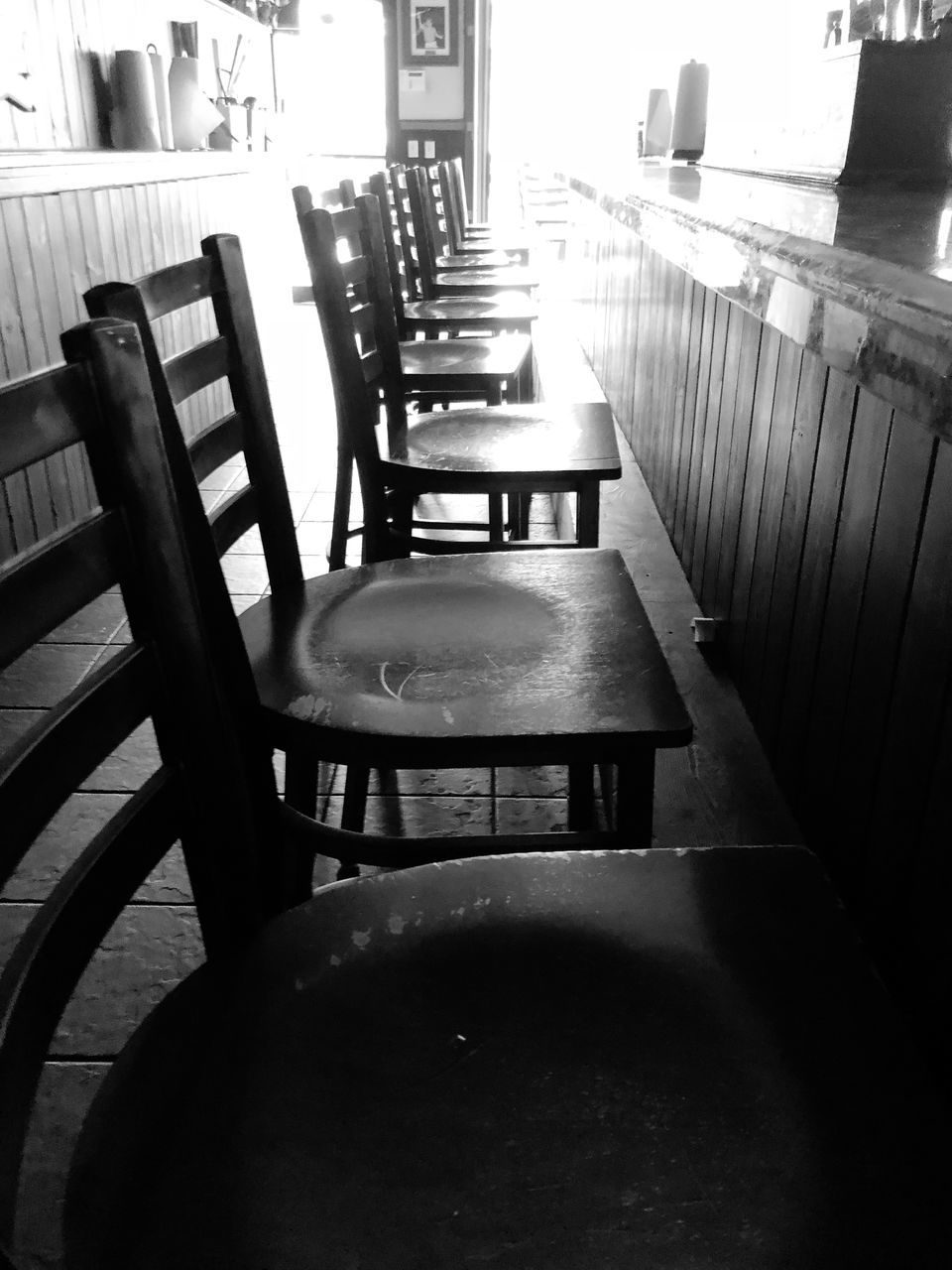 EMPTY CHAIRS AND TABLE AT CAFE