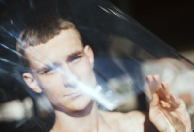 Portrait of young man holding camera