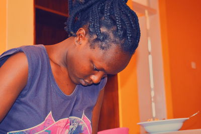 Close-up of young woman at home