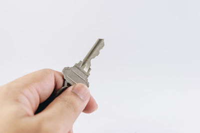 Close-up of hand holding hands against white background