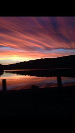 Scenic view of lake against romantic sky at sunset