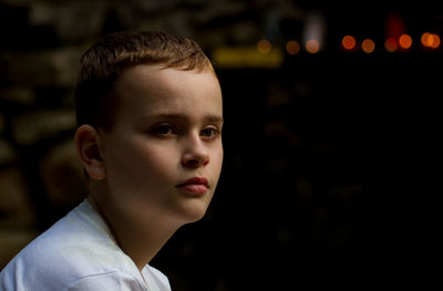 Close-up portrait of boy looking away outdoors