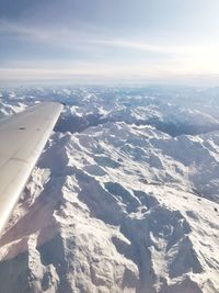 Aerial view of snowcapped mountains against sky