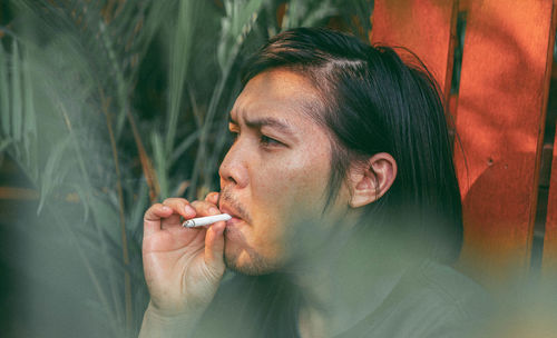 Portrait of man smoking cigarette