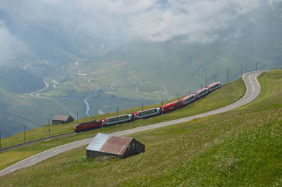 Distant view of train with mountain range in background